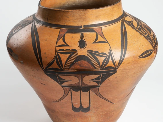 A large Hopi jar with polychrome designs painted on a field of yellow clay.