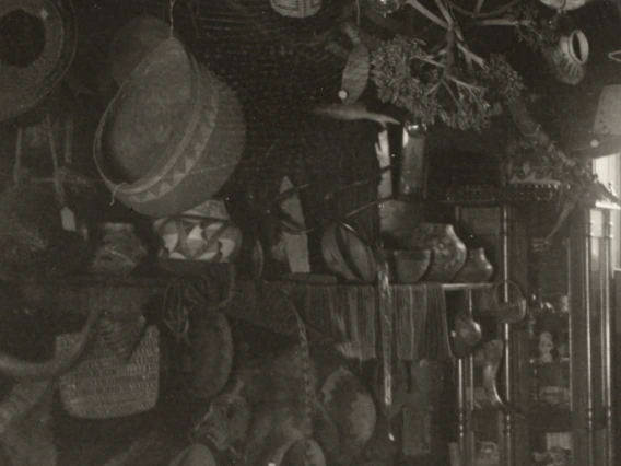 Detail of living room view, showing pottery on a fireplace mantle.