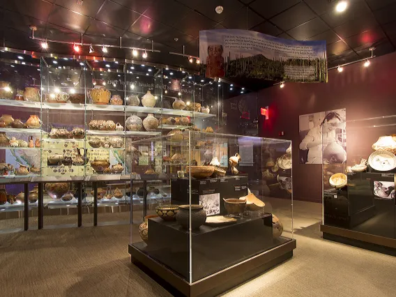 view of the pottery gallery display cases and the Wall of Pots.