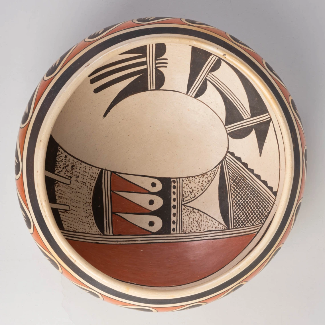 a polychrome bow with avian designs on the interior