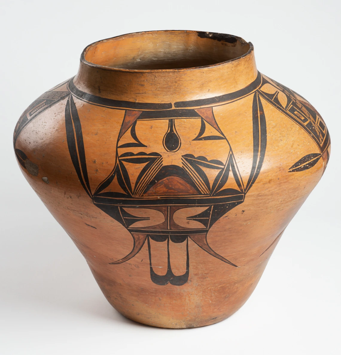 A large Hopi jar with polychrome designs painted on a field of yellow clay.