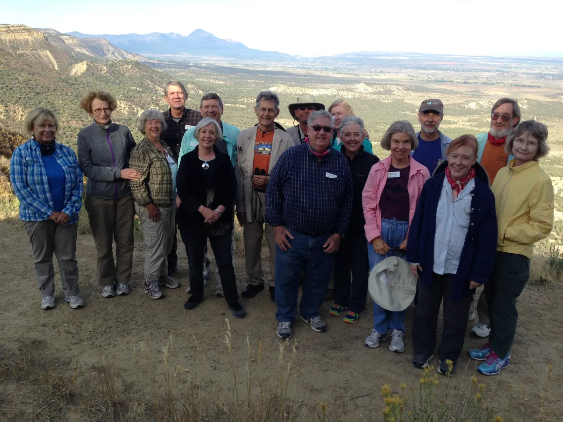 a group of members stopping for a quick picture at Mesa Verde National Park