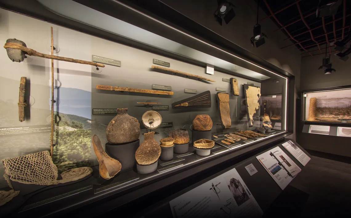 a view into one of the cases displaying archaeological basketry and other fiber objects.