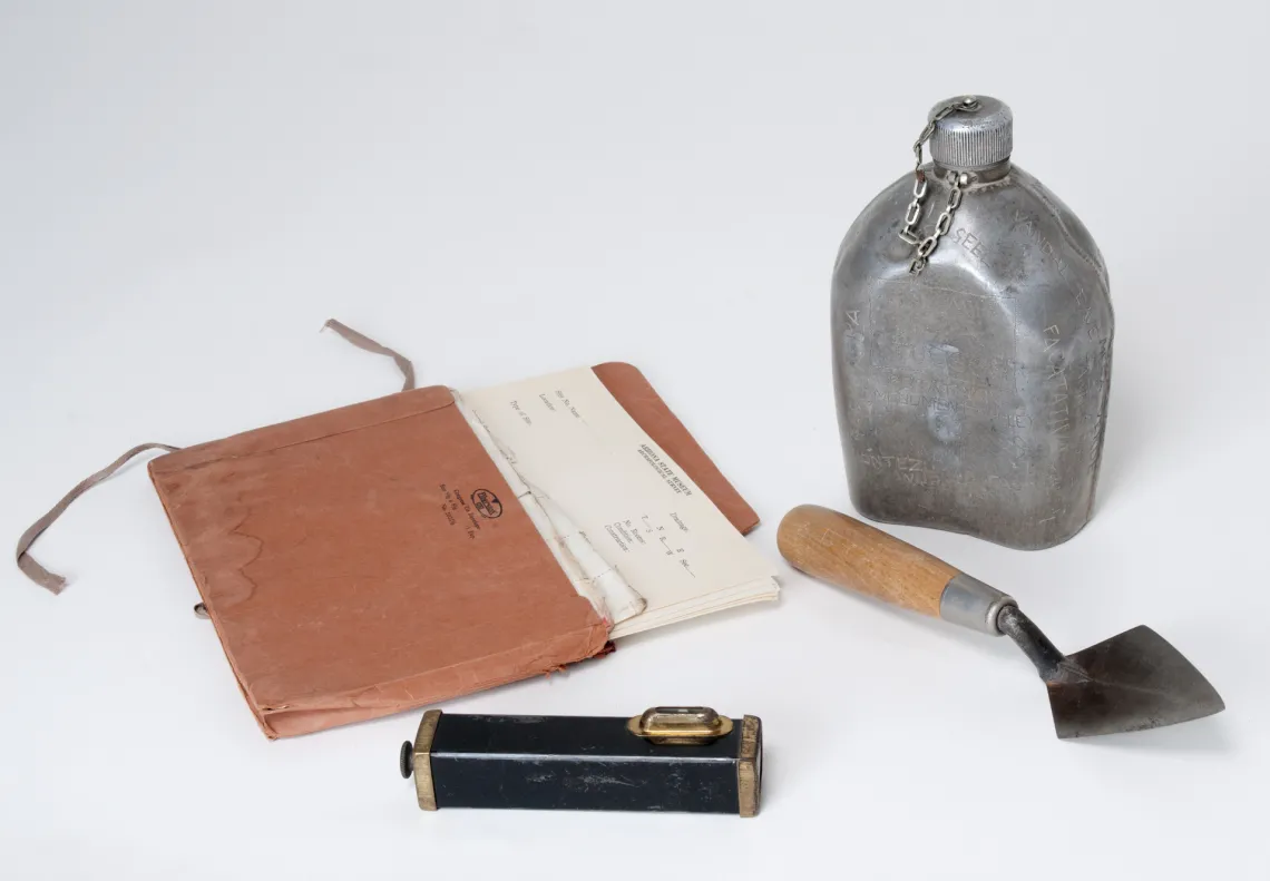 Metal canteen with the names and dates of his expeditions scratched into the surface