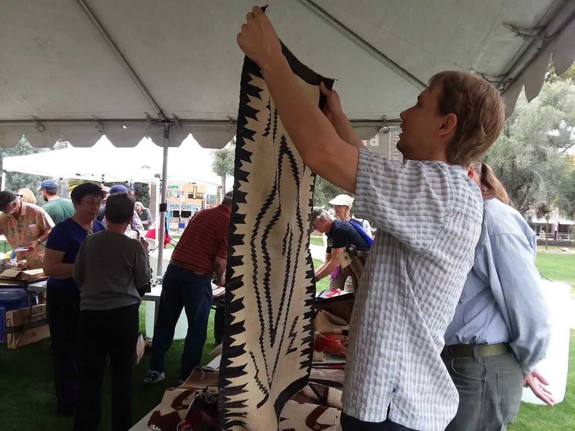 Man holding rug